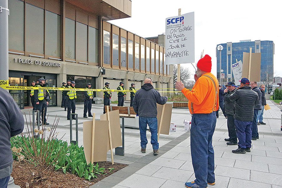 Unionized workers make noisy statement outside council meeting
