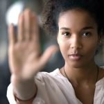 Confident african young woman showing stop signal.
