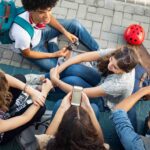 Multiethnic friends laughing and talking after school lesson